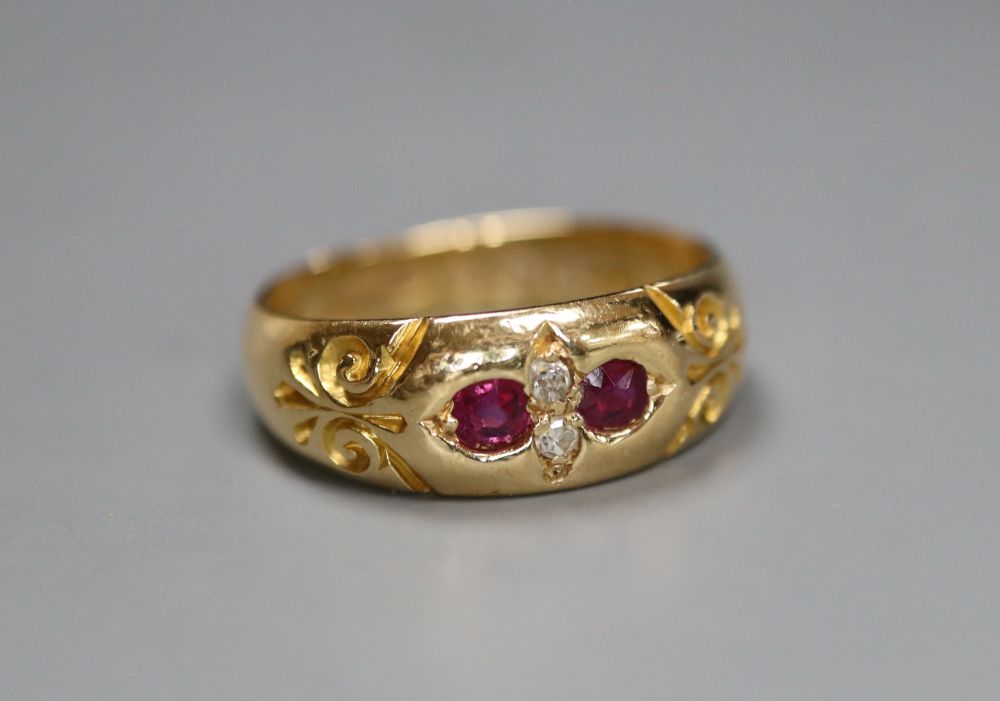 A late Victorian 18ct gold and gypsy set two stone diamond and two stone ruby ring, size K/L, gross 4.4 grams.